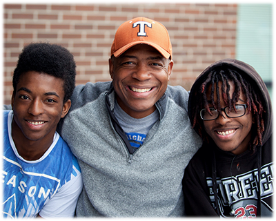photo of volunteer with two boys 
