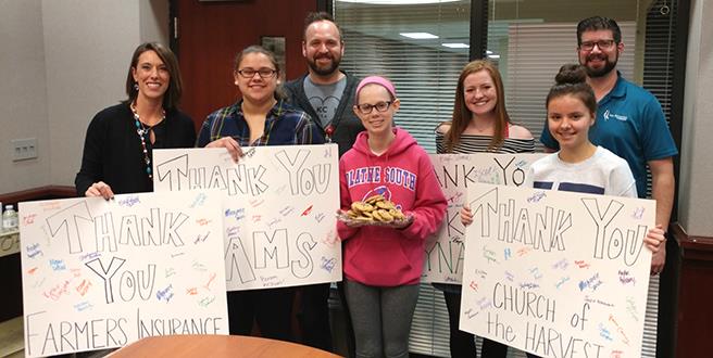 photo of people holding Thank You signs 