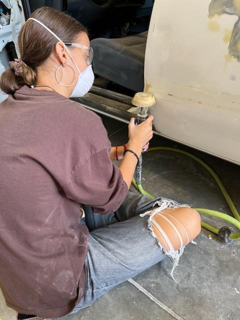 Jasmine removing molding tape from car door