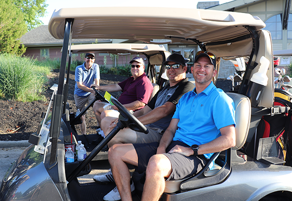 photo of four men in golf carts
