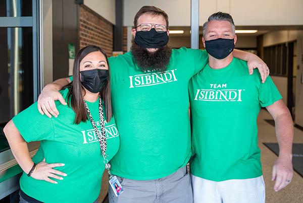 photo of three educators in matching shirts