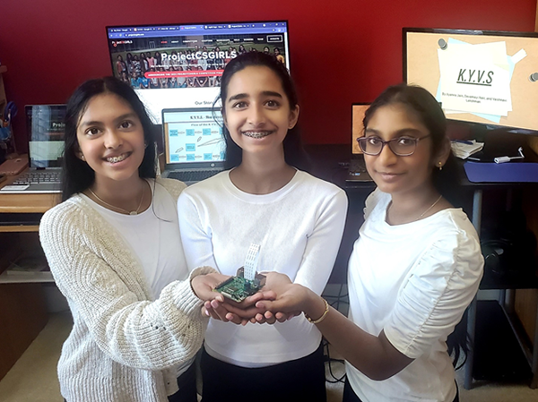 photo of three girls holding software