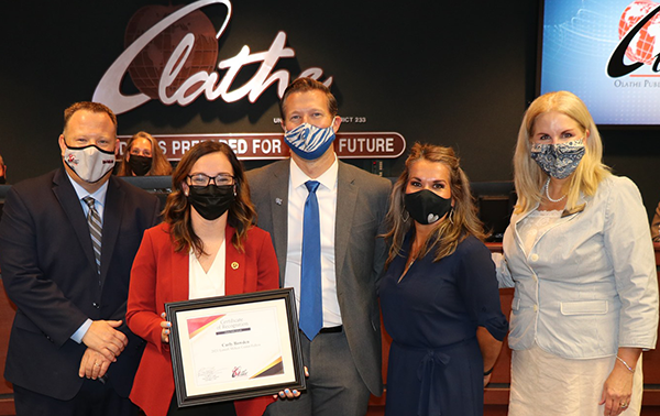 photo of woman holding certificate