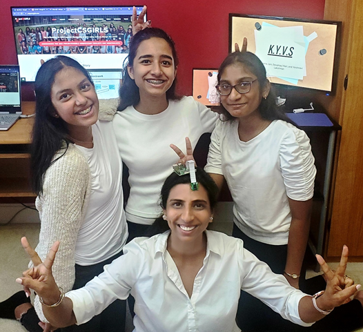 photo of three girls with their coach