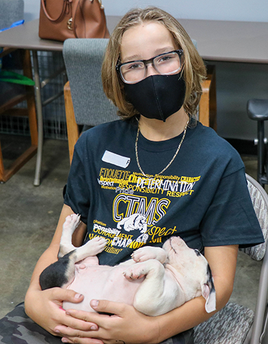photo of student holding puppy