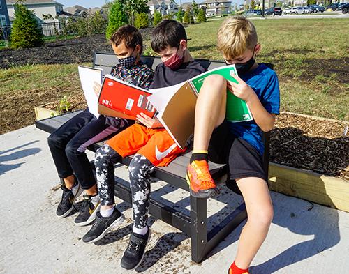 photo of boys sitting on bench