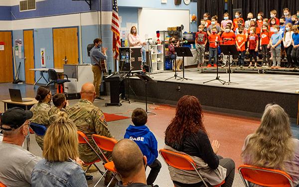 audience watches and listens to students sing