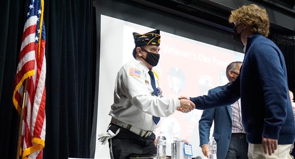 student and veteran shake hands