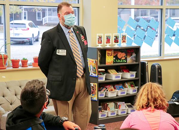 man talking to students