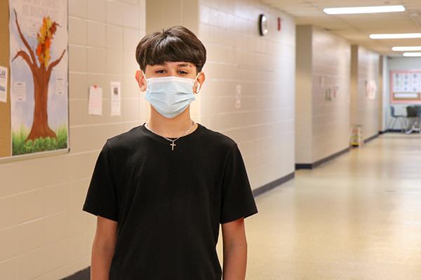 boy standing in hallway