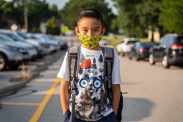 boy walking in parking lot