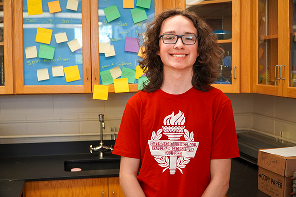 Logan standing in science classroom
