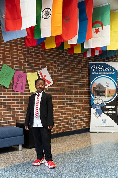 Sekou stands underneath flags of many nations