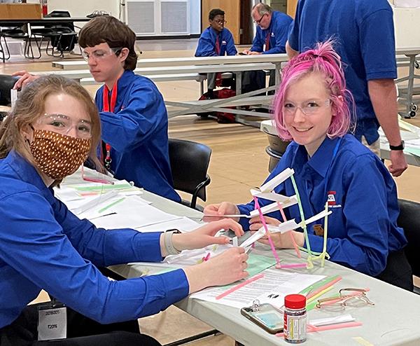 students build something with straws and paper