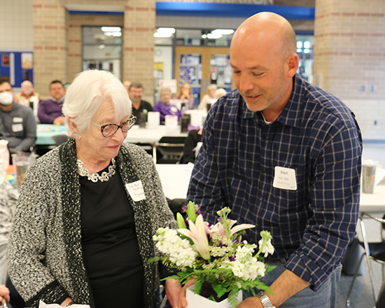 woman receives flowers from man