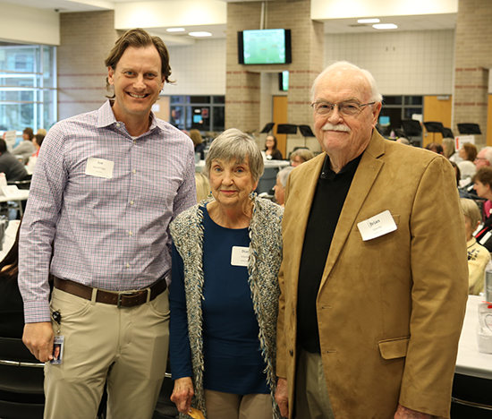 man presents pins to couple