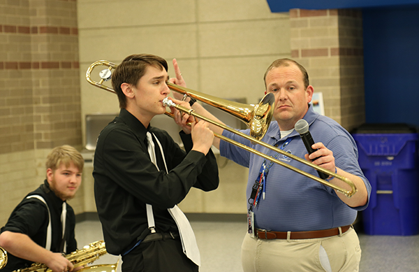 high school student plays trombone