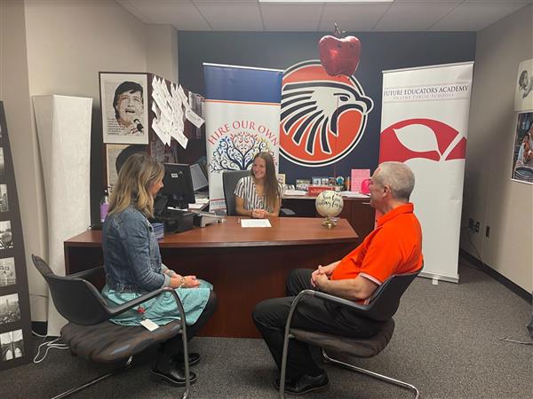 Brooke being presented her contract 