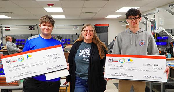 two boys hold mock checks