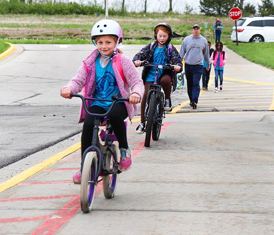 students on bikes form a line