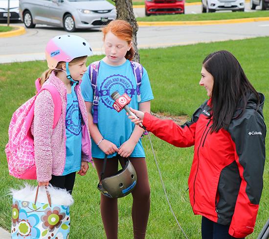 TV reporter interviews two girls