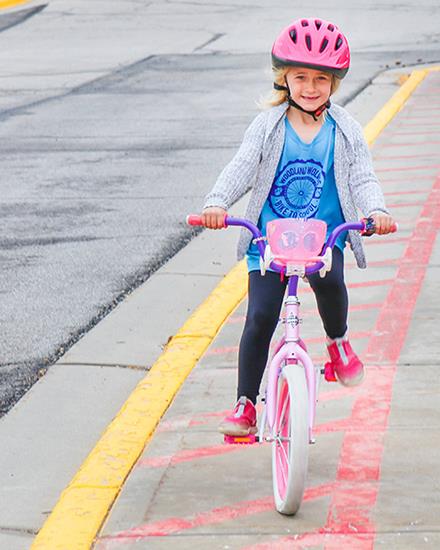 girl riding pink bicycle