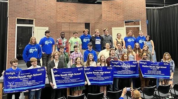 students hold award banners