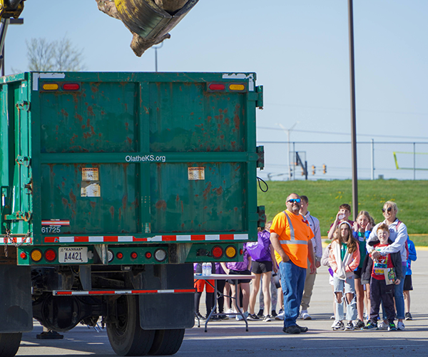 students watch backhoe and dump truck