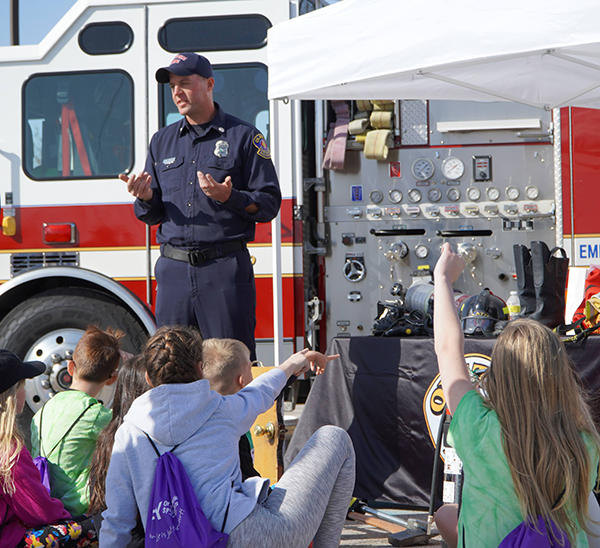 firefighter talks to children about his career