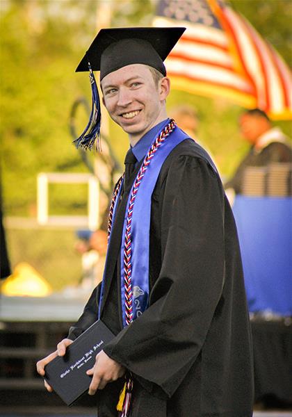 boy holds diploma
