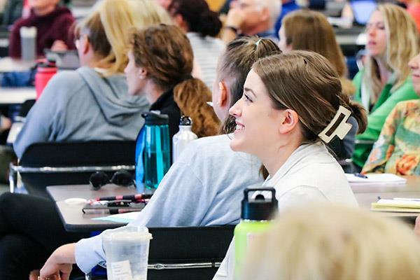 Photo of educator listening to a presentation at Summer Conference