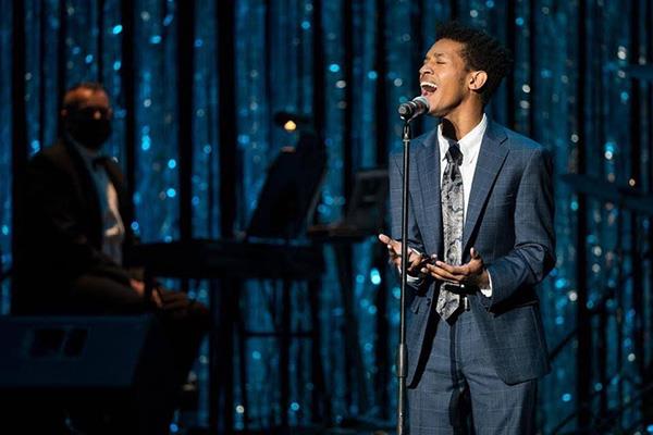 teen sings at microphone