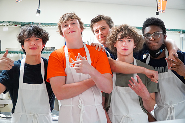 five boys dressed in aprons