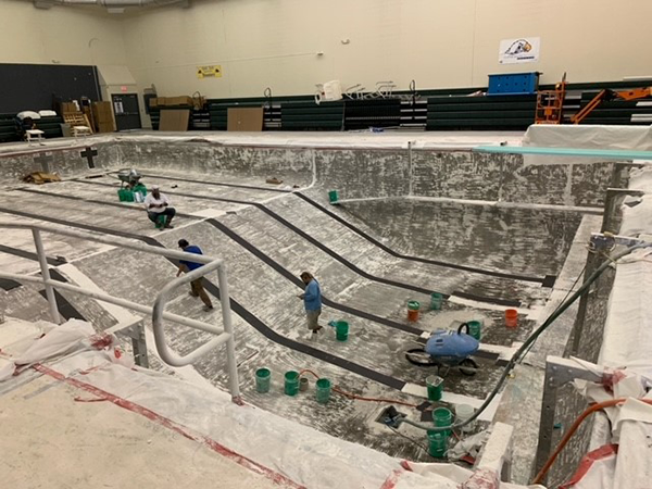 workers renovate the swimming pool