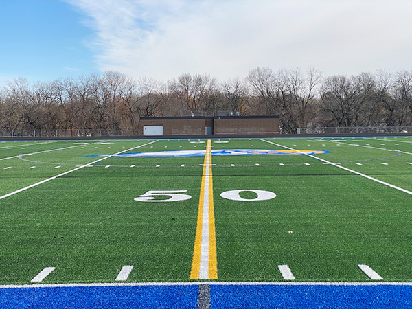 closeup of newly installed turf field with Falcon logo