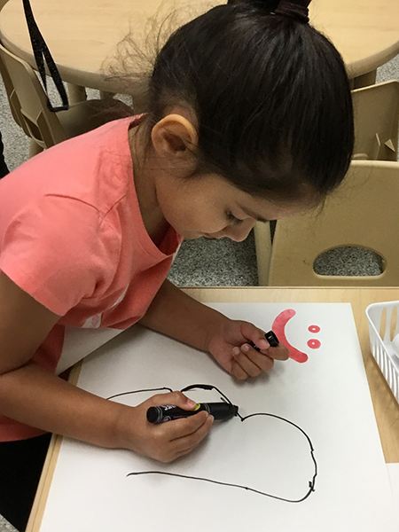 child draws on paper