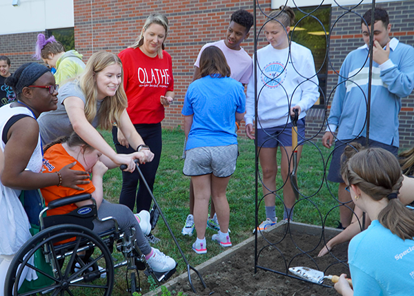 students work together to dig and plant