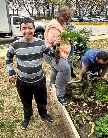 student holds bunch of carrots