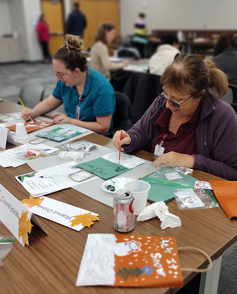 employees decorate holiday gift bags