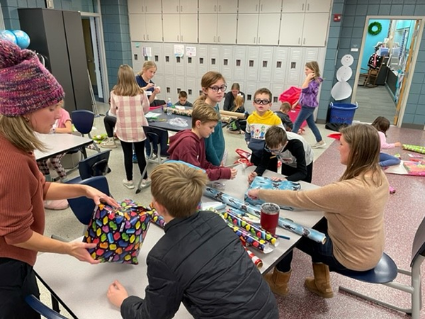 students wrap presents
