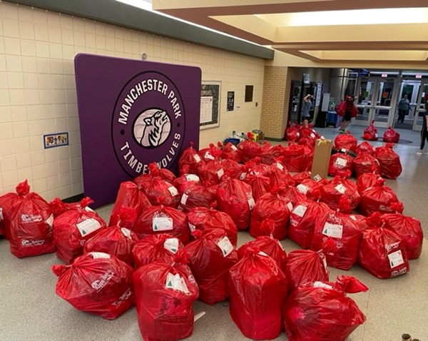 piles of red bags filled with gifts