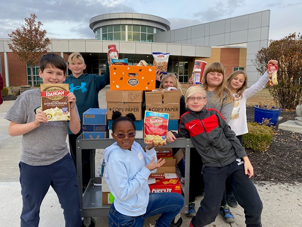 students and a cart of donated food