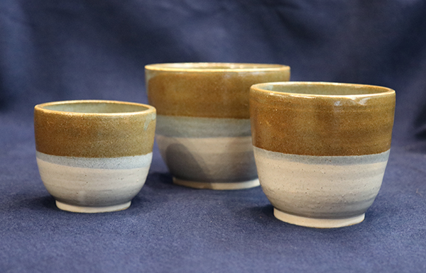 three stoneware planters in earthtones