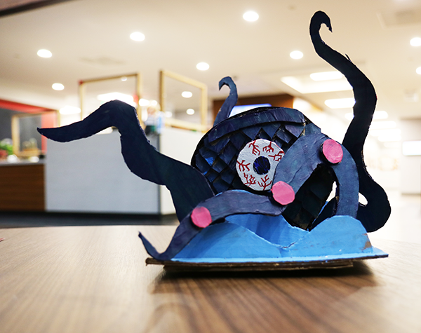 cardboard sculpture of a creature morphed from two creatures