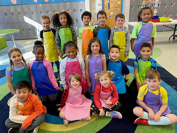 group of first grade students sitting on floor