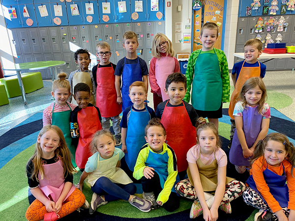 group of students wearing aprons