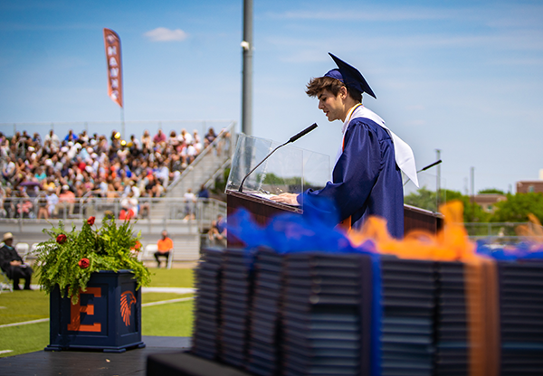 boy addresses classmates from the stage