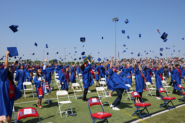 graduates toss their caps at graduation