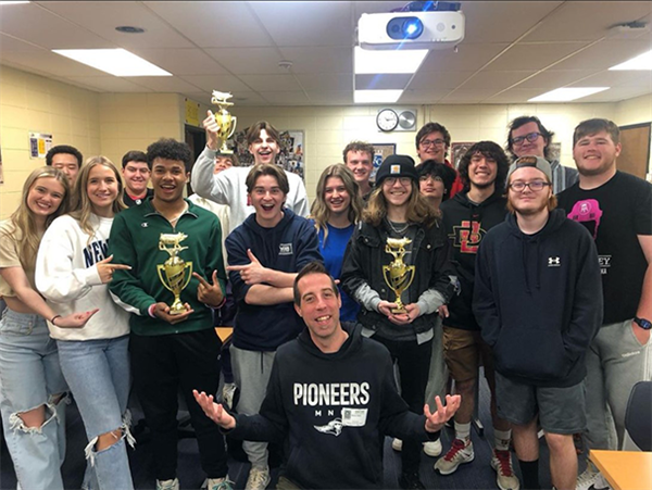 high school students hold two trophies earned for their films