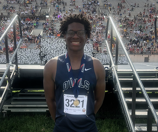 boy wearing state high jump medal